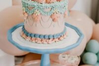 17 a pretty bright lambeth wedding cake done in pink, turquoise, blue, various sugar patterns and cherries placed on top
