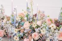 18 a gorgeous spring wedding tablescape with blush, blue and lilac blooms and greenery, blue and lilac candles and blue napkins