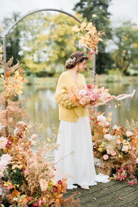 an oversized mustard cardigan will accent your bridal look and keep you warm at the same time
