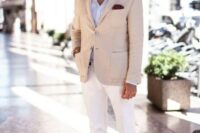 20 a chic look with a light blue shirt, a tan blazer, white pants, tan leather moccasins and sunglasses
