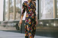 20 a fantastic moody floral maxi dress with puff sleeves, black boots, a purple hat and a small black bag with a round handle for a fall wedding