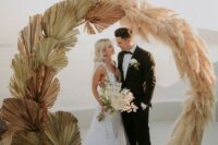 20 a round wedding arch partly covered with pampas gras and partly with dried fronds looks very cool and stylish