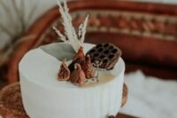 20 a simple buttercream wedding cake topped with figs, lotus and grasses is a gorgeous idea for a fall wedding