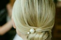 20 a super elegant twisted low bun with pearl pins and a sleek top for a minimalist bride
