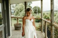 21 a strapless wedding ballgown with a thihg high slit and a full skirt, a corset and a train is pure elegance and it looks amazing