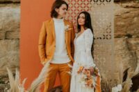 22 a groom wearing a marigold suit, a white turtleneck, brown shoes for a 70s inspired fall wedding