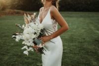 22 a plain mermaid wedding gown with a deep neckline and side lace inserts plus a sweeping train looks wow