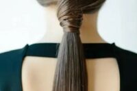 23 a sleek twisted low ponytail is a stylish idea for a modern or minimalist bride