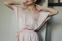 23 pink silk pajamas with a laced up neckline and a sash is a cool alternative to a robe or a dress