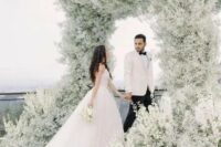 24 a jaw-dropping wedding arch that feels like a cloud as it’s fully covered with white baby’s breath is amazing