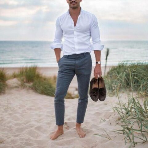 a relaxed summer wedding guest look with a white shirt, grey pants and brown loafers is a lovely idea