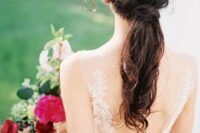 24 a stylish modern wedding ponytail with some twists coming from top to the bottom and a volume on top