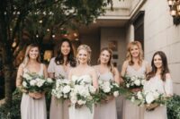 25 a bride wearing a strapless mermaid wedding dress with a train, bridesmaids rocking mismatching neutral maxi dresses