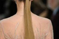 25 a tall sleek ponytail wrapped with hair, with a sleek top is a stylish idea for a modern or minimalist bride