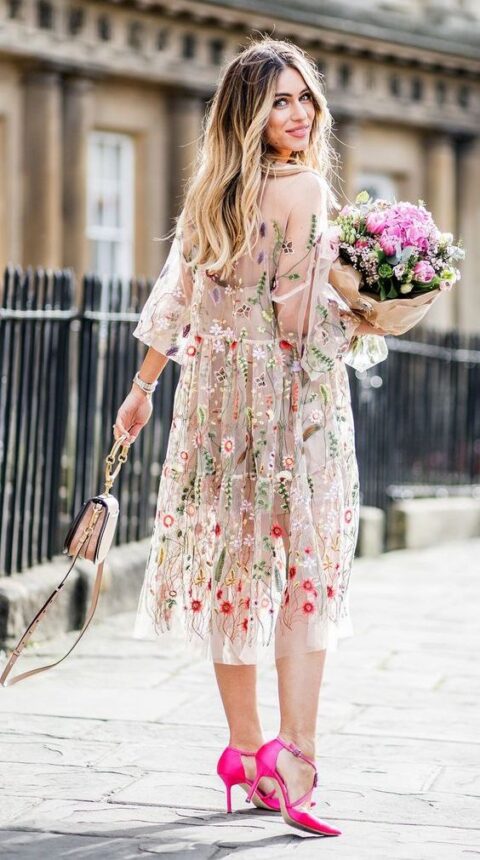 a lovely midi dress with colorful floral embroidery, hot pink shoes, a blush bag with a ring handle for a spring or summer wedding