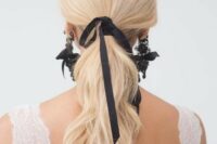 27 a wavy ponytail with a black ribbon and matching black lace and ribbon earrings by Marchesa