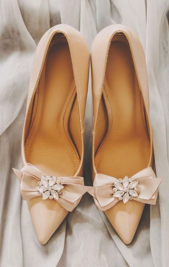 classic pointed toe nude wedding shoes with bows and rhinestone flowers are amazing for a glam wedding