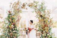 28 a fabulous and textural fall wedding arch with burgundy, pink and yellow blooms, greenery and fall foliage is amazing for an autumn celebration