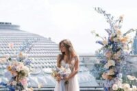 28 a pastel wedding altar of light blue, bold blue, blush blooms and greenery is a beautiful idea for a spring wedding