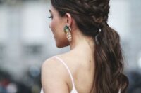 28 a wavy ponytail with a bump and a braided halo for a casual and modern bride