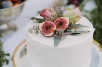 28 a white buttercream wedding cake with figs and pink roses on top is an elegant and stylish idea for a boho wedding in the fall