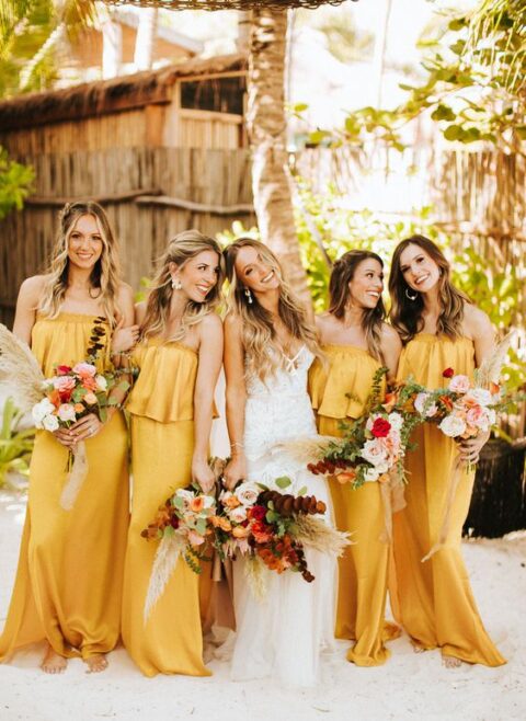 yellow strapless maxi bridesmaid dresses with a tiered bodice are very cool and they add to the tropical theme