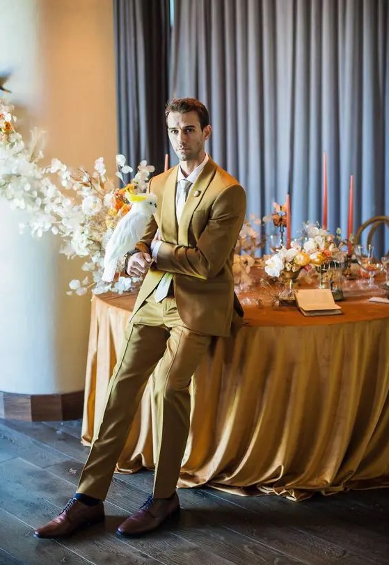 a stylish look with a yellow suit, a white shirt and white tie, brown shoes and blue socks for a summer wedding