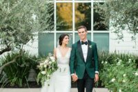 30 a beautiful green tuxedo with black lapels, a black bow tie, black pants and loafers compose a refined groom’s look