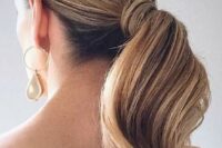 30 an elegant and refined low wavy ponytail with a sleek top is a stylish idea for a modern or minimalist bride, wrap the ponytail with your hair