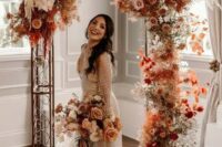 30 an incredible bright boho fall wedding arch with rust-colored and pink and blush roses, white orchids, pampas grass, rust-colored fall foliage just excites