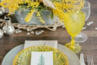 31 a bold spring wedding tablescape with mimosa blooms, a yellow and green plate, a yellow glass and crystals