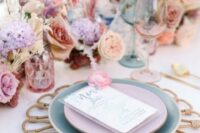 31 a pastel wedding tablescape with lilac, dusty pink and peachy blooms, pampas grass and rattan placemats plus pastel plates