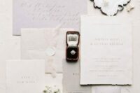 32 a delicate and refined neutral wedding invitation suite with lilac and gray pieces, a raw edge and calligraphy is amazing