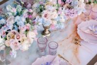 32 a pretty pastel wedding tablescape with refined pink plates, pastel florals, tall and thin candles and pink glasses