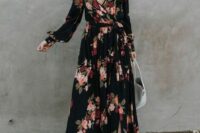 32 a sophisticated black maxi wrap wedding guest dress with long sleeves, blush shoes and a white bag for a fall or winter wedding