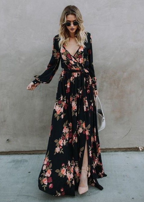 a sophisticated black maxi wrap wedding guest dress with long sleeves, blush shoes and a white bag for a fall or winter wedding