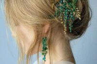 33 a cool updo with some mess and texture, with locks down and a jaw-dropping gold and emerald hairpiece is wow
