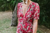 33 a statement summer wedding guest look with a red floral dress with buttons and short sleeves, a plunging neckline, white floral earrings and a leopard print clutch