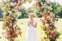 34 a jaw-dropping wedding arch with some foliage, pink, blush, red and neutral blooms all over is amazing for a bright summer wedding