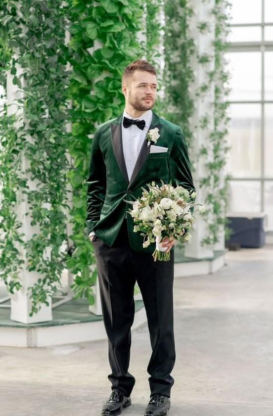 an elegant groom's look with an emerald velvet blazer with black lapels, a bow tie and black shoes