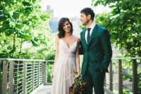 35 an emerald groom’s suit paired with a navy tie, brown shoes and a white shirt for a bold modern look