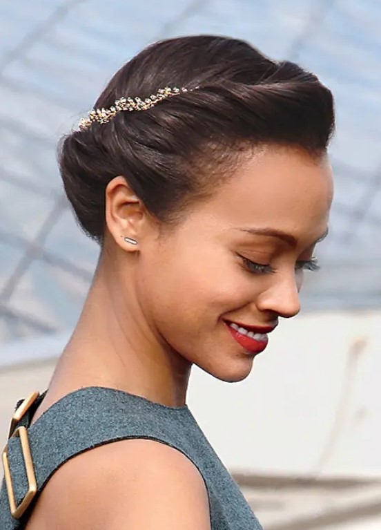 a laconic low updo with a small volume on top and a gold branch wedding headpiece for an accent