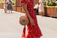 36 a vintage-styled red floral midi dress with short sleeves and a V-neckline, red heels and a straw bag