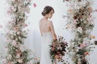 37 a fabulous and delicate spring wedding arch with white, blush and light pink blooms and greenery balanced with a bit of dark ones