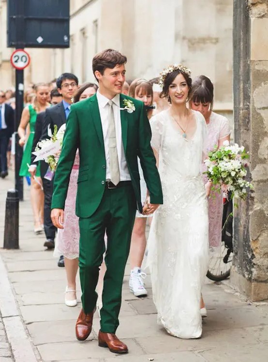 an emerald suit with a nude tie and brown shoes for a stylish vintage-inspired wedding