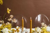 38 a charming spring wedding tablescape with neutral linens, yellow and white blooms, mustard candles, white and gold cutlery