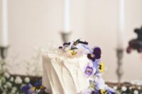 38 a white textured buttercream wedding cake topped with pansies is an ultimate summer wedding idea