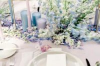 39 a spring wedding tablescape with blue and blush candles, blue and white florals and neutral plates is chic