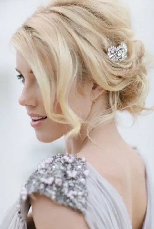 a messy and wavy updo with some volume on top, some locks down and an embellished hairpiece is a gorgeous idea to try