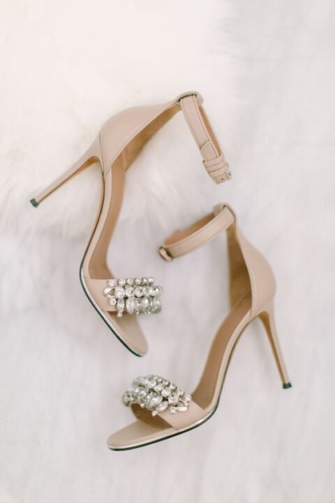 nude wedding shoes with ankle straps and heavily embellished straps are a great idea for a chic and glam bridal look